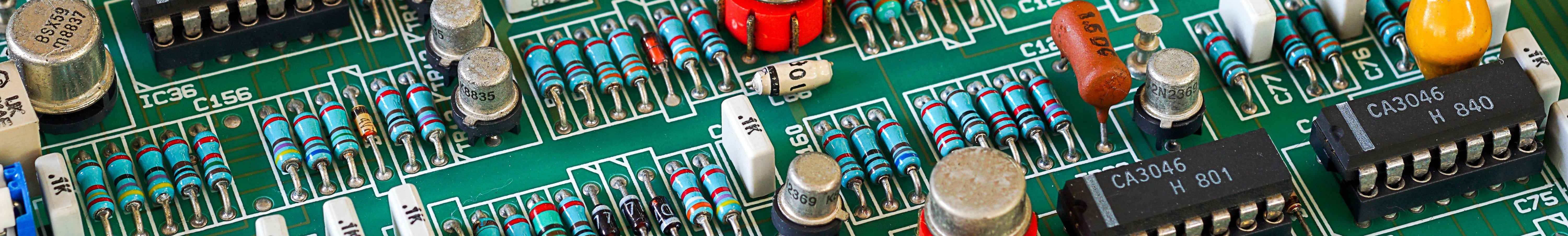 Close-up of a green circuit board with various electronic components.